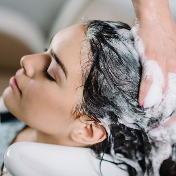 Cropped Hands Of Hairdresser Washing Customer Hair At Salon cropped hands of hairdresser washing customer hair at salon