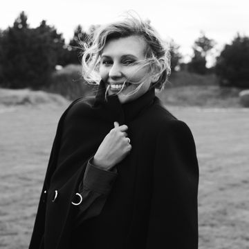 olena zelenska wears a black cape coat outside