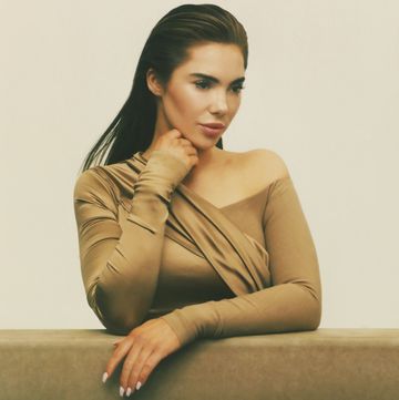 mckayla maroney posing on a balance beam in a beige gown mckayla maroney posing on a balance beam in a beige gown