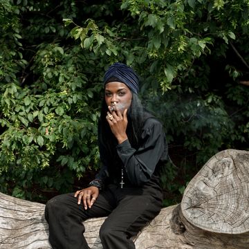 Sitting, Botany, Photography, Outerwear, Footwear, Tree, Headgear, Black hair, Photo shoot, Leisure, 