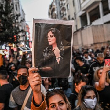 topshot a protester holds a portrait of mahsa amini during a demonstration in support of amini, a young iranian woman who died after being arrested in tehran by the islamic republic's morality police, on istiklal avenue in istanbul on september 20, 2022 amini, 22, was on a visit with her family to the iranian capital when she was detained on september 13 by the police unit responsible for enforcing iran's strict dress code for women, including the wearing of the headscarf in public she was declared dead on september 16 by state television after having spent three days in a coma photo by ozan kose afp photo by ozan koseafp via getty images