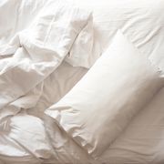 messy bed white pillow with blanket on bed unmade top view