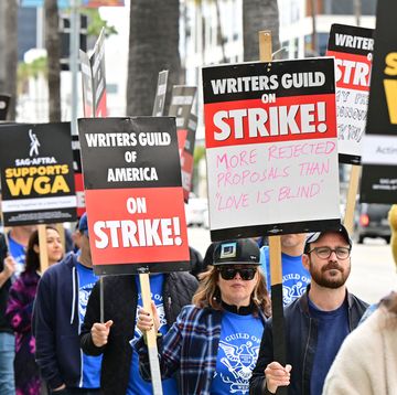 US-ENTERTAINMENT-FILM-STRIKE writers on strike march with signs on the picket line on day four of the strike by the writers guild of america in front of netflix in hollywood, california on may 5, 2023 more than 11,000 hollywood television and movie writers are on their first strike since 2007 after talks with studios and streamers over pay and working conditions failed to clinch a deal photo by frederic j brown afp photo by frederic j brownafp via getty images