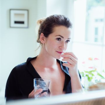 woman taking vitamins and supplements