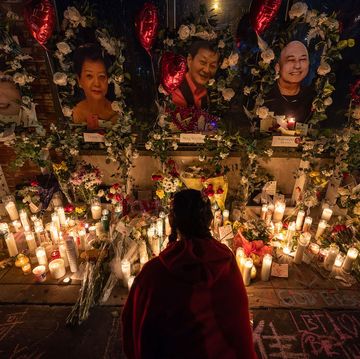 a young woman lights incense at a vigil for those murdered during a mass shooting at star ballroom dance studio in monterey park, california